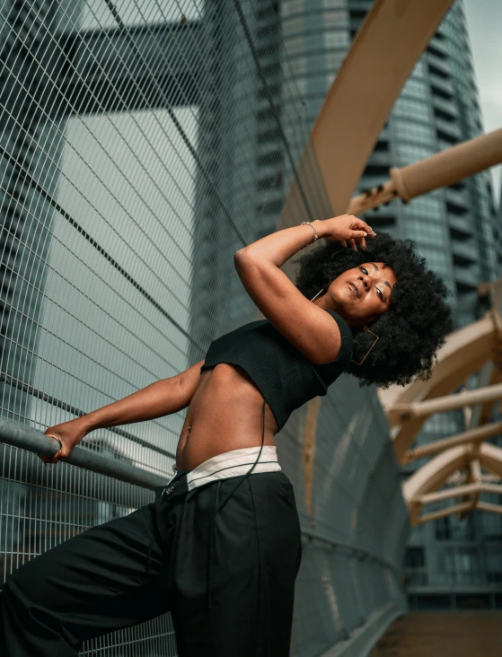 woman posing for pograph with skyscrs in the background