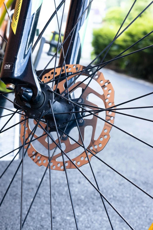 the spokes on a bicycle are brown and black