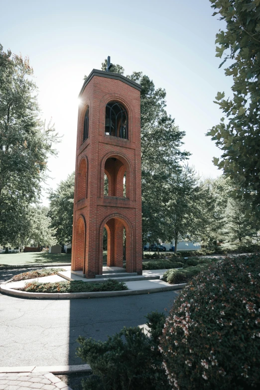 this is a small brick tower in the middle of trees