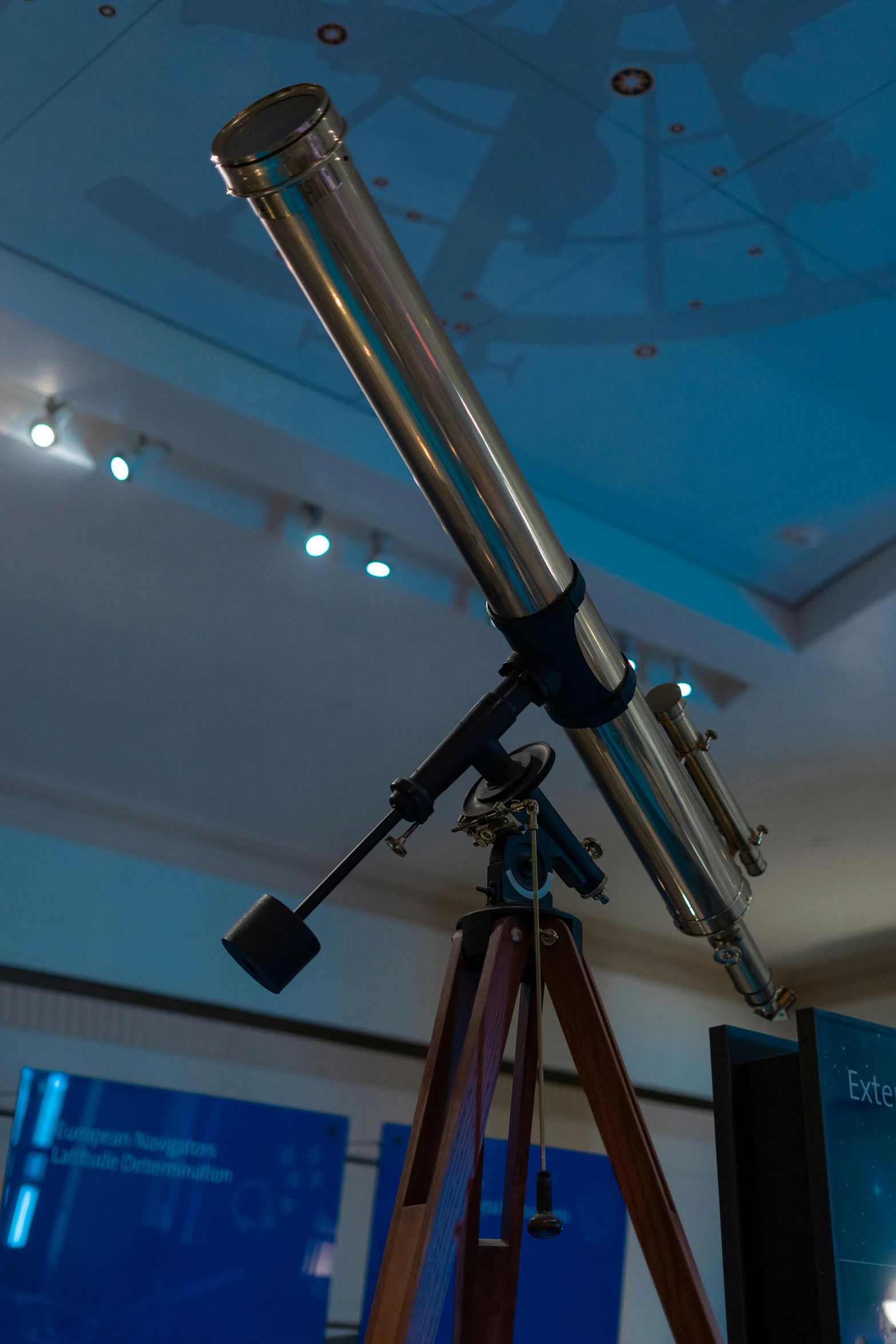 a telescope set up on a tripod in the middle of a room