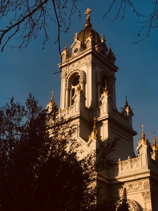 a building with a clock tower next to trees