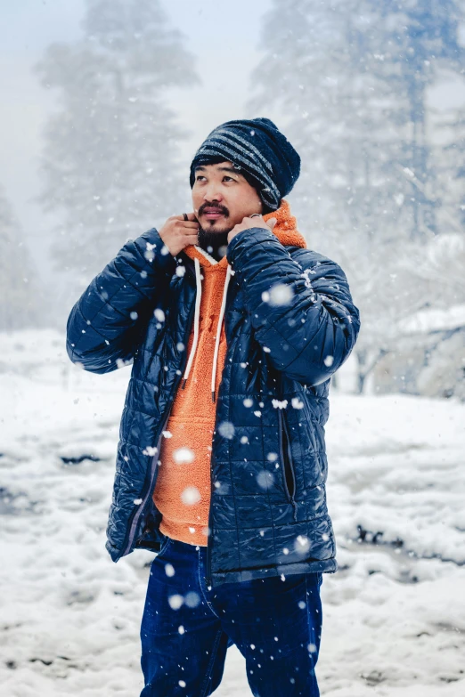 the man stands in a snow storm outside