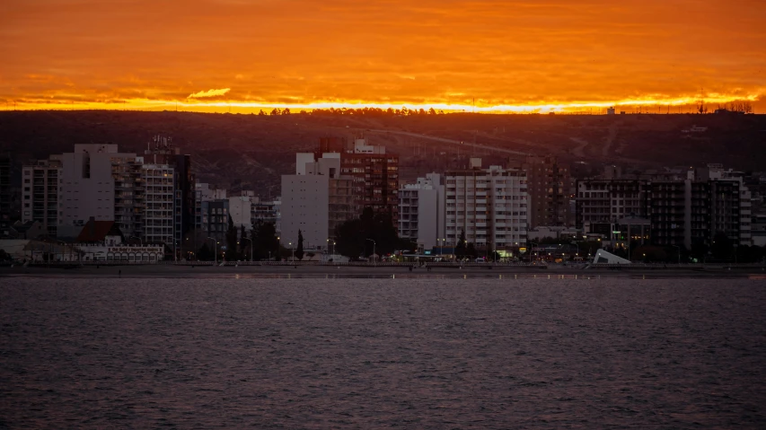 an orange and yellow sky looms above the skyline