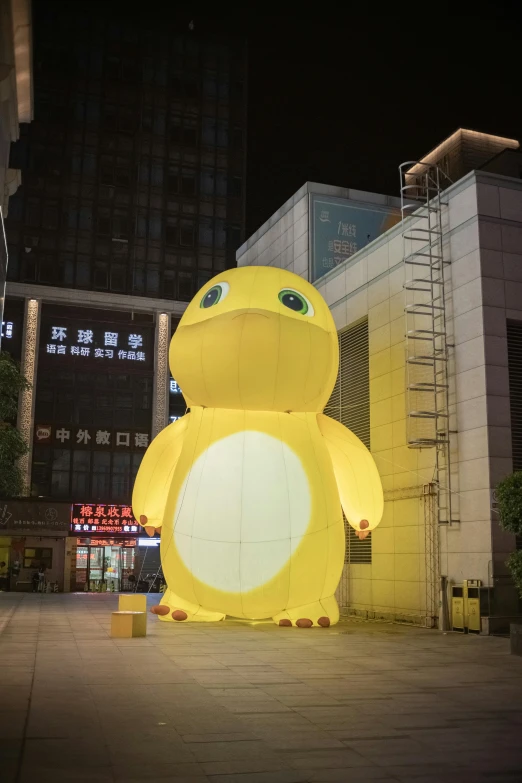 a yellow pokemon character sitting in the middle of a street