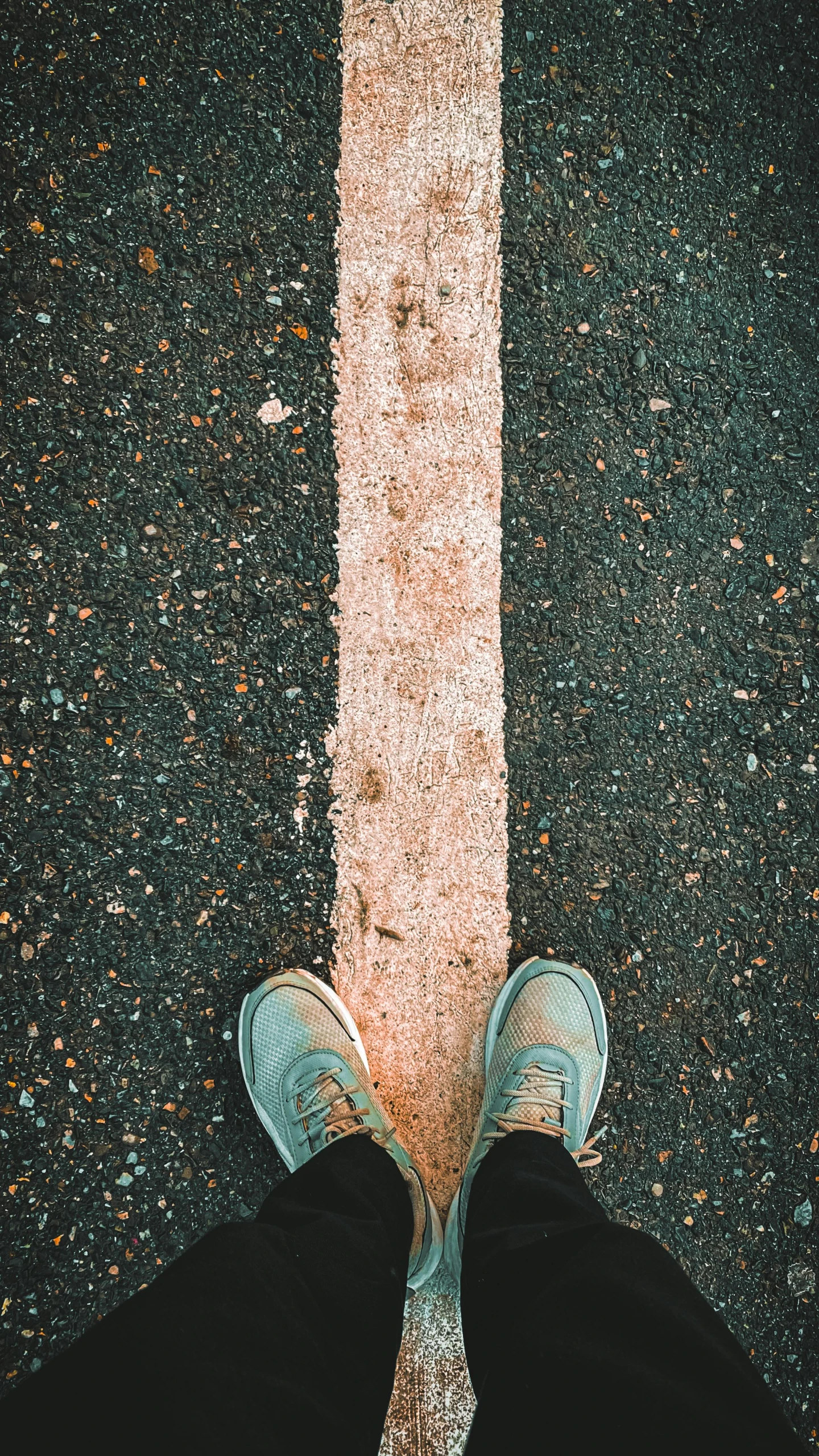 the back view of a person standing on pavement