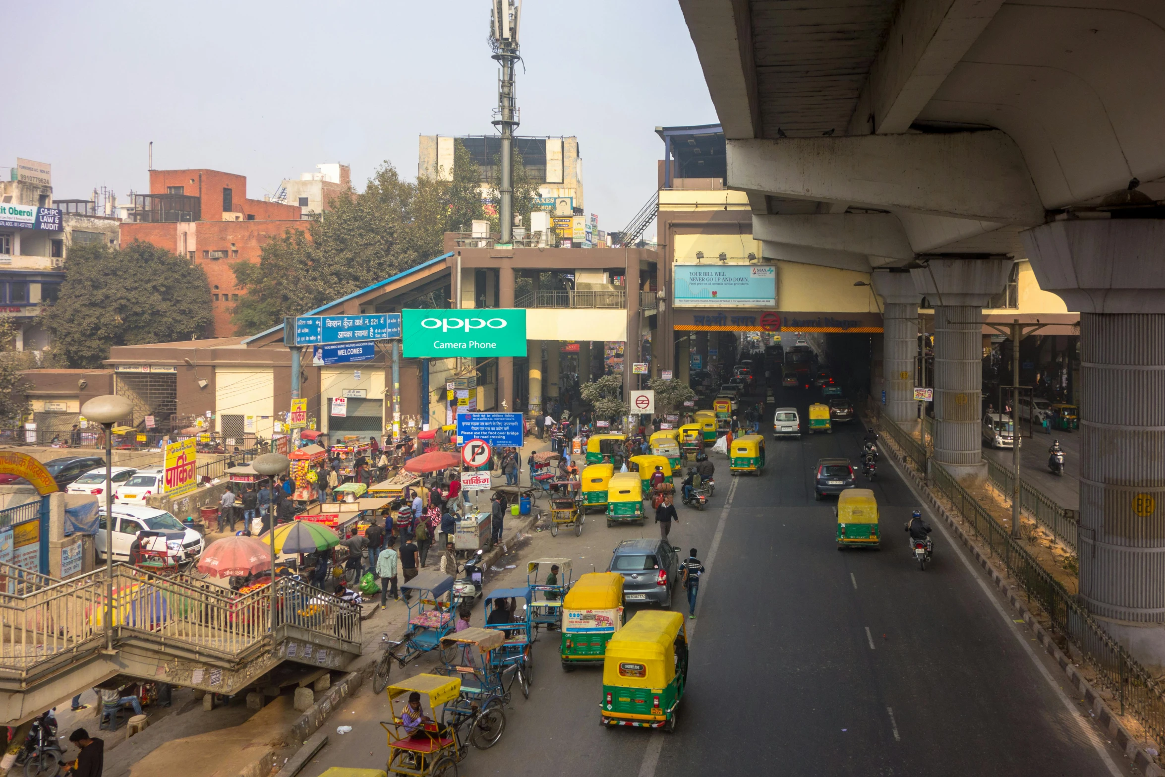 a busy road with people and several vehicles