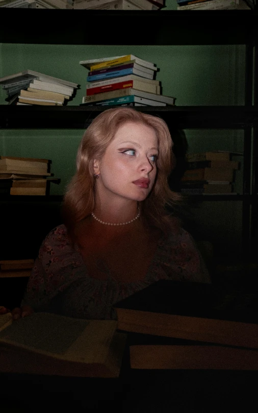 woman standing in front of shelves in a liry