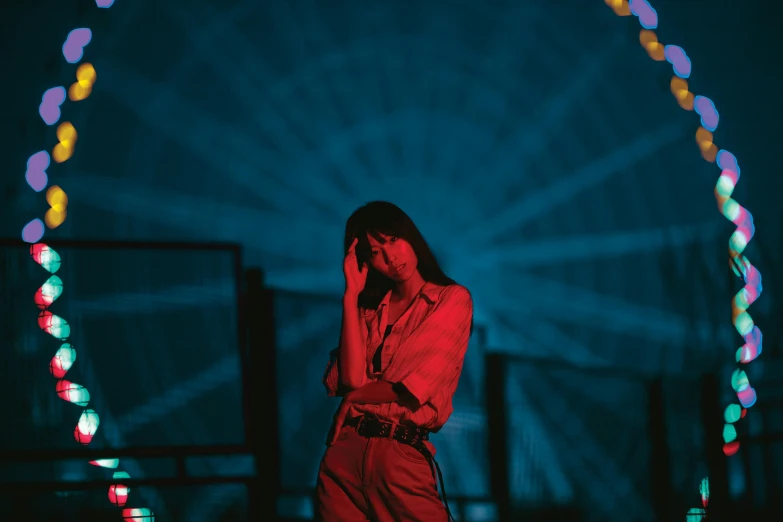 a woman talking on the phone at a carnival ride