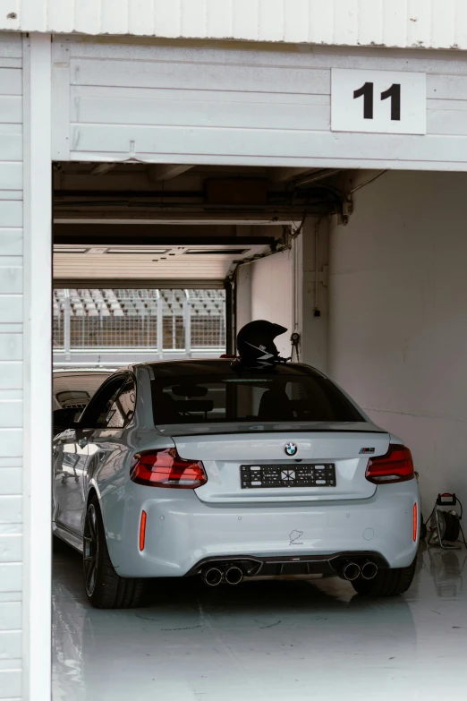a gray sports car in a white garage