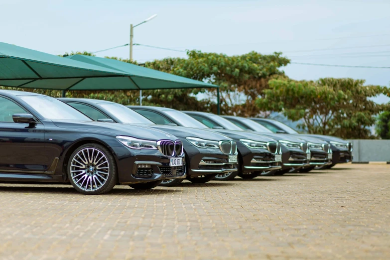 there are several cars parked under an umbrella