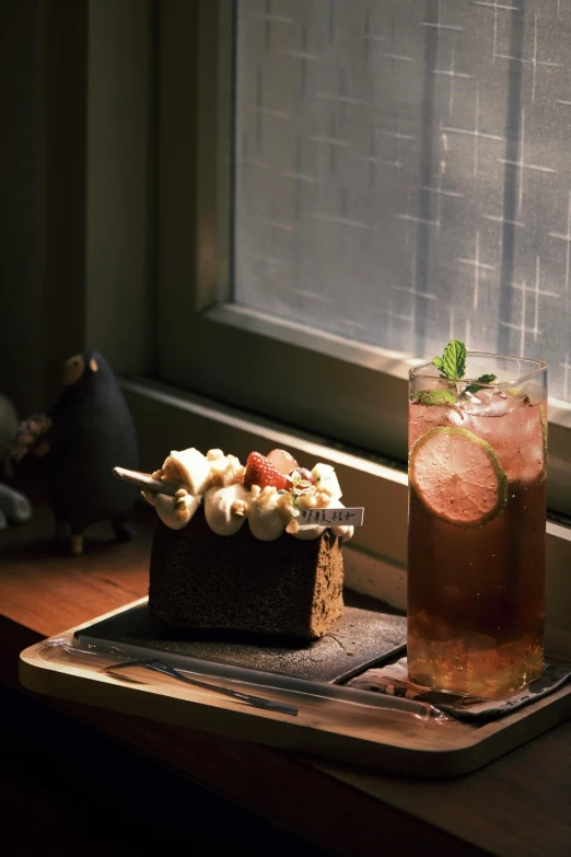 there is a table with an ice tea, cake and dessert on it