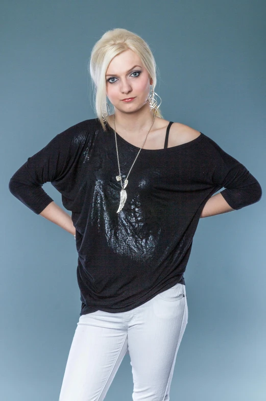 a blonde girl with short white hair, wears jeans and a t - shirt