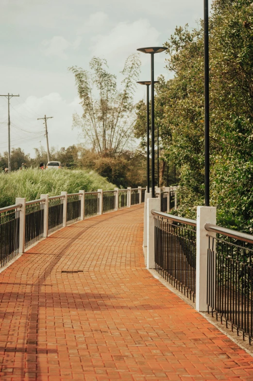 a brick pathway running through a rural countryside