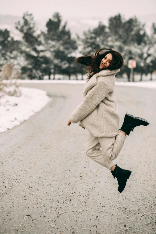 a woman jumps in the air while jumping in the street