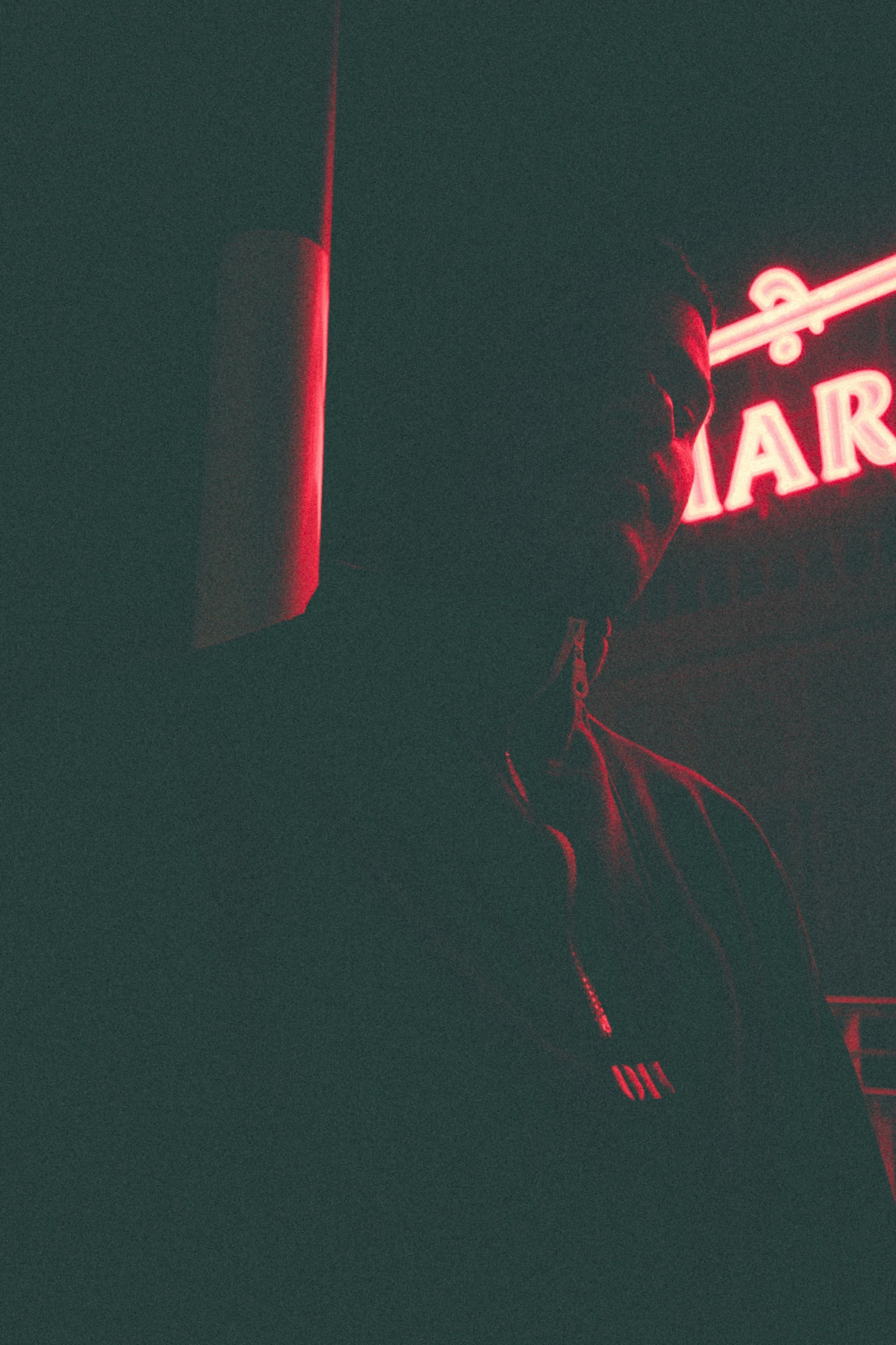 a red light above a sign for a bar