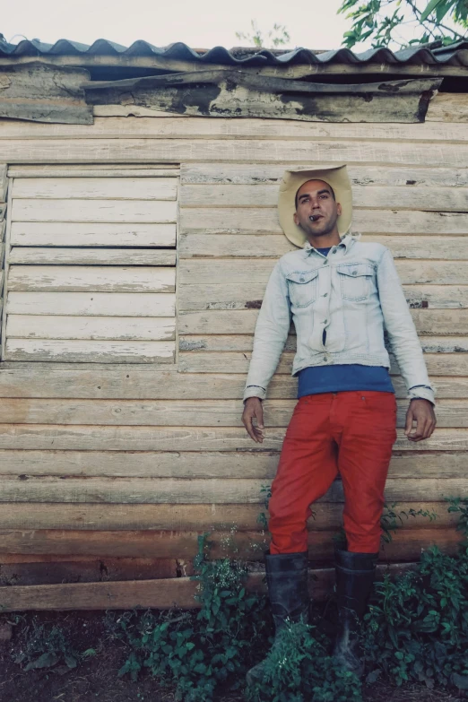 a man in red pants and a cowboy hat