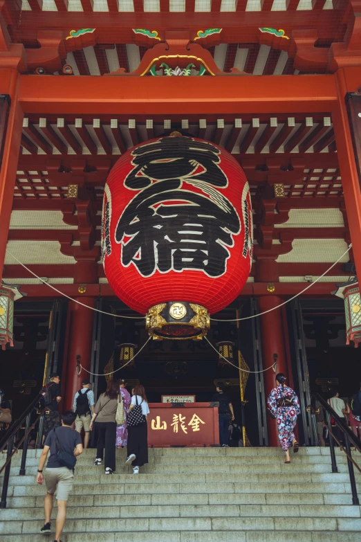 some stairs with a red lantern above it