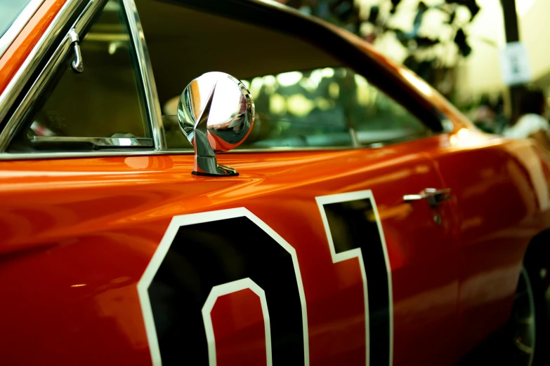 the side view of a red sports car that is painted to look like it is getting it's own paint job