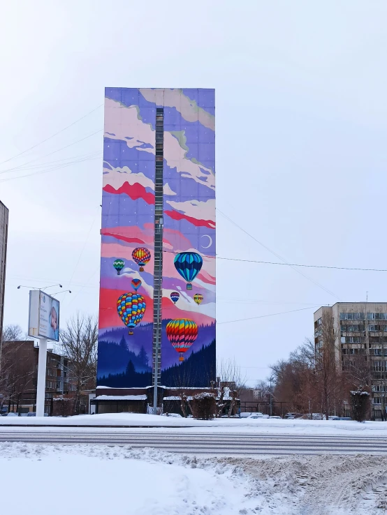 a very tall billboard has balloons painted on it