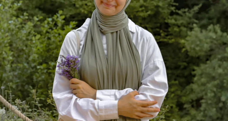 an image of woman holding flowers in her hands