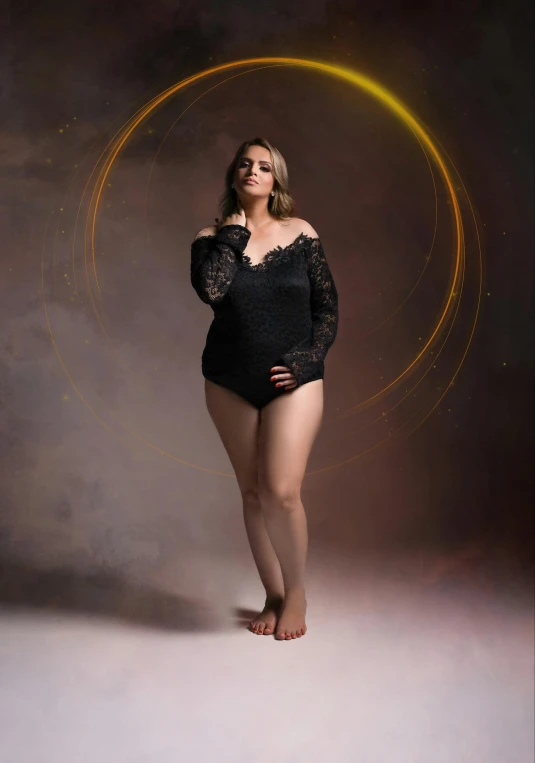 the woman is posing in her black bodysuit