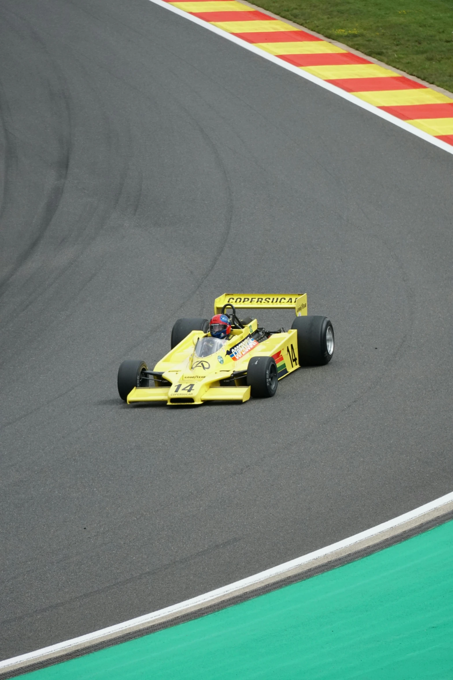 the formula race car is driving along the track