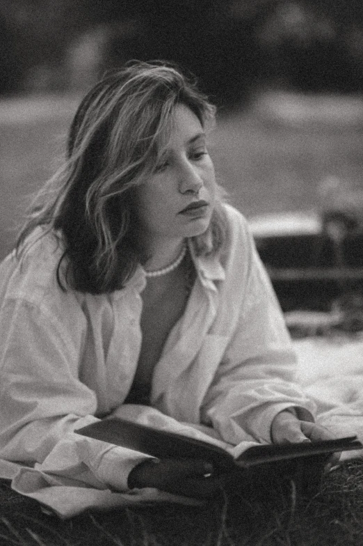 a young woman is sitting down reading