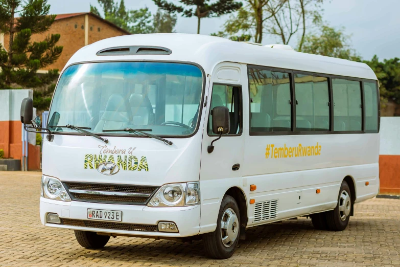 a white bus with passengers sits on the ground