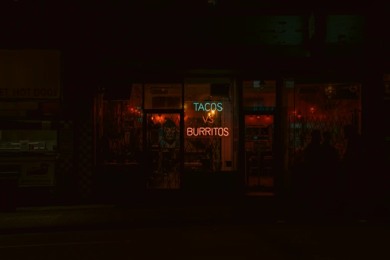 a dark room with signs saying and neon lights