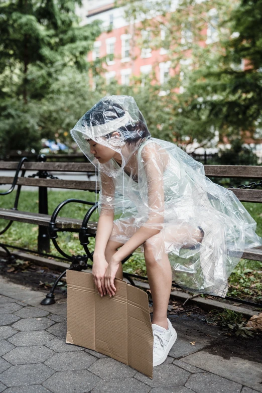 a girl is dressed up as a plastic sheet