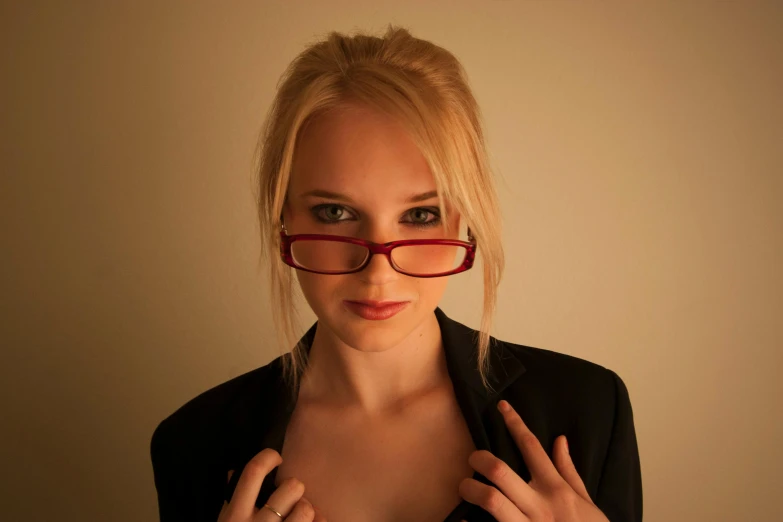 the girl is wearing red glasses, posing