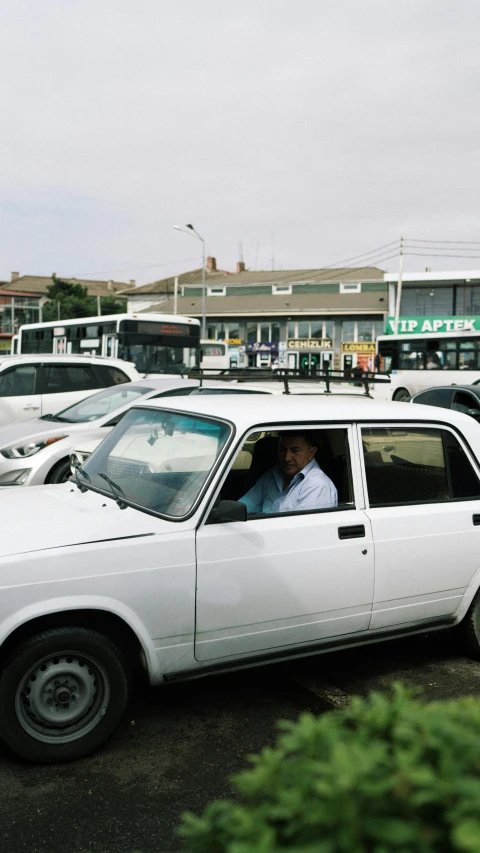 people sit in a parked station wagon