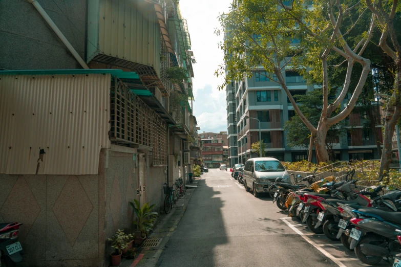 many motorcycles lined up on the curb of a city street