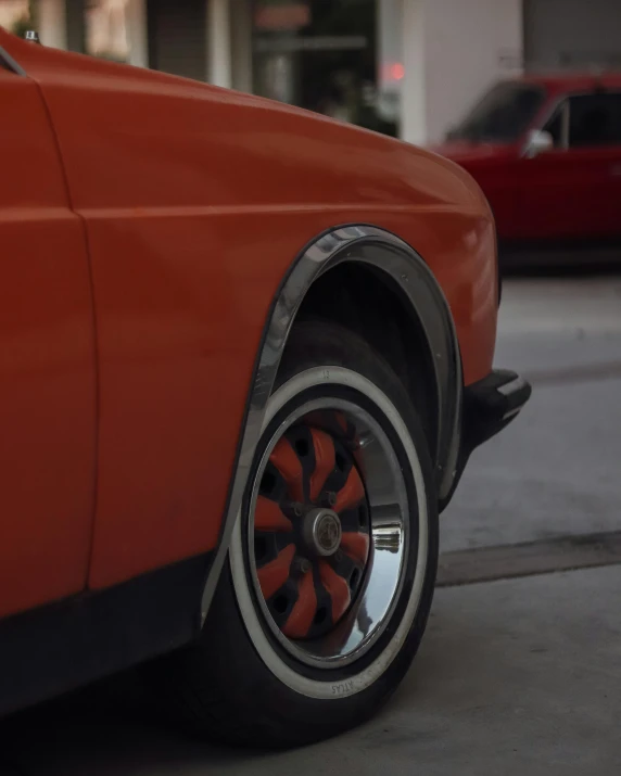 closeup of the side of an orange classic car