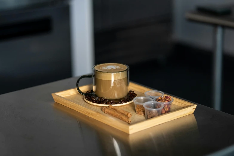 a cup of coffee on top of a wooden plate