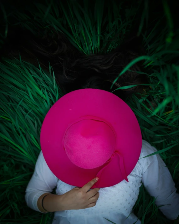 a person with a large pink hat over their head