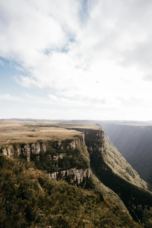 a person standing on top of a large cliff