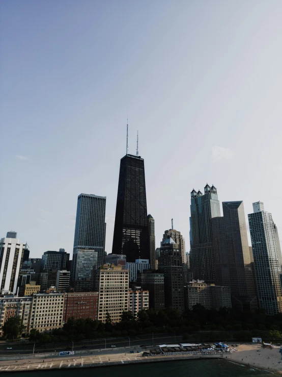 the city skyline as seen from the waterfront of a lake