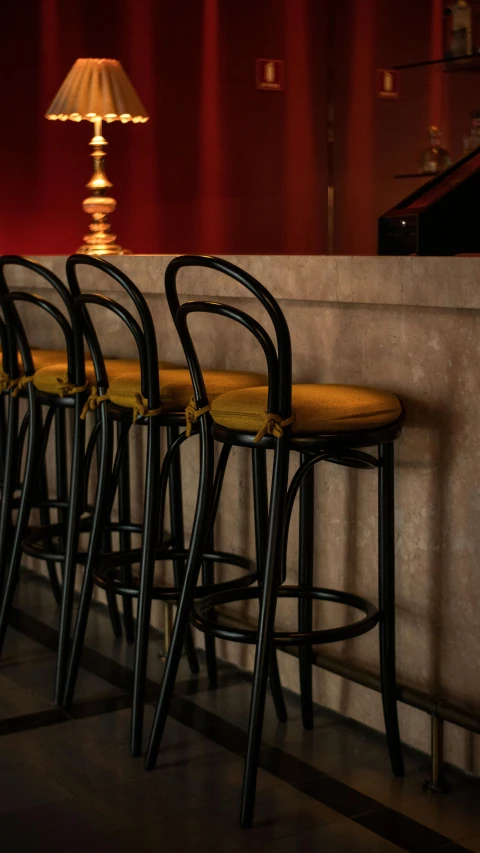 three bar stools at the edge of a room