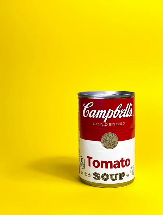 a can of soup is shown against a yellow background
