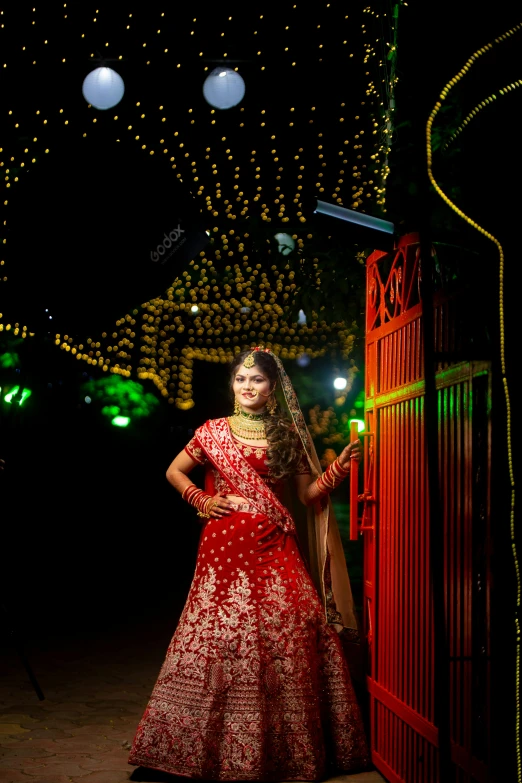 a woman dressed in a red outfit poses for the camera