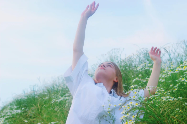 a woman reaching up to catch a frisbee