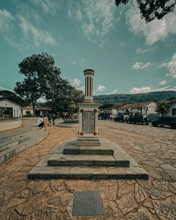 a monument sitting in the middle of a dirt covered field