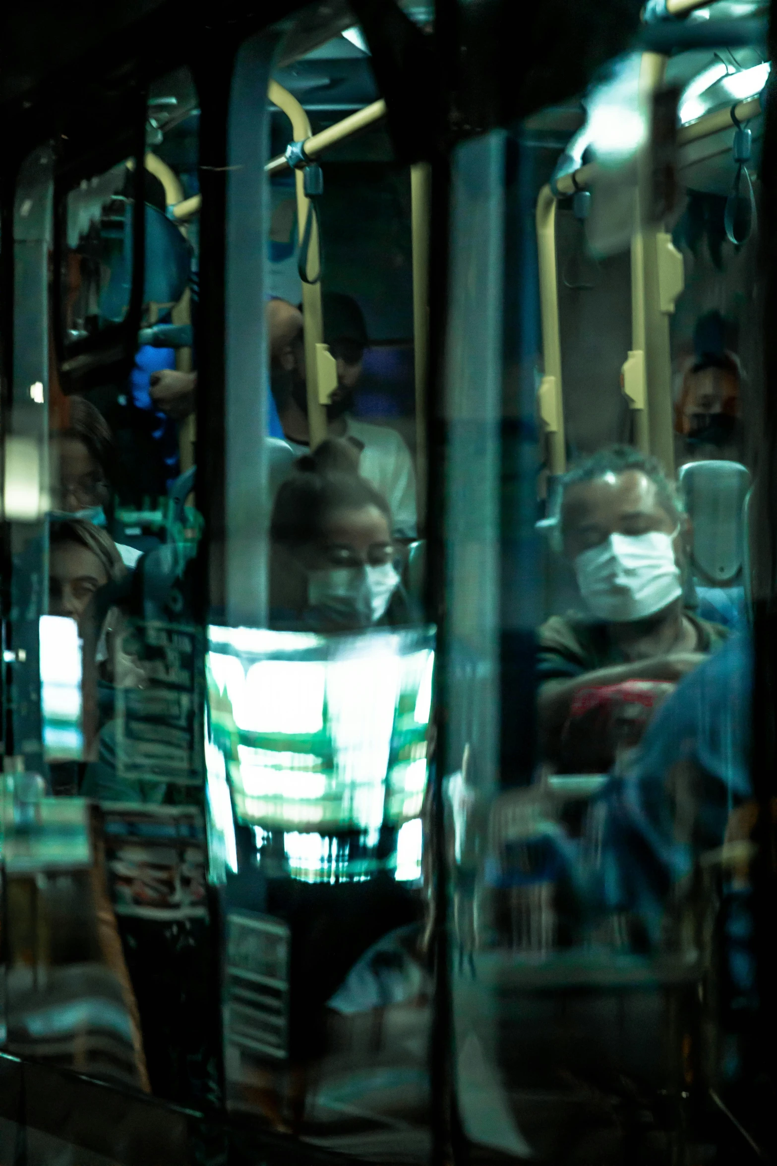 many people are seated on public transit buses