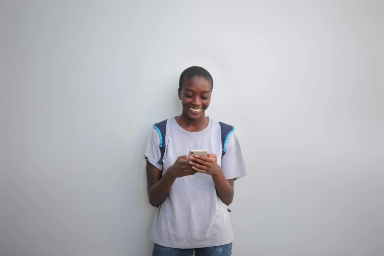 an african american woman is standing in front of a white wall