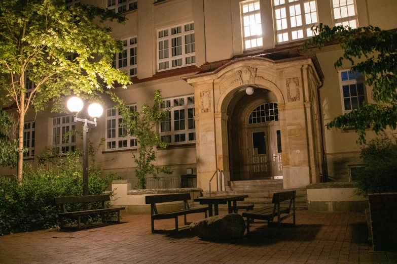 an open courtyard with benches at night