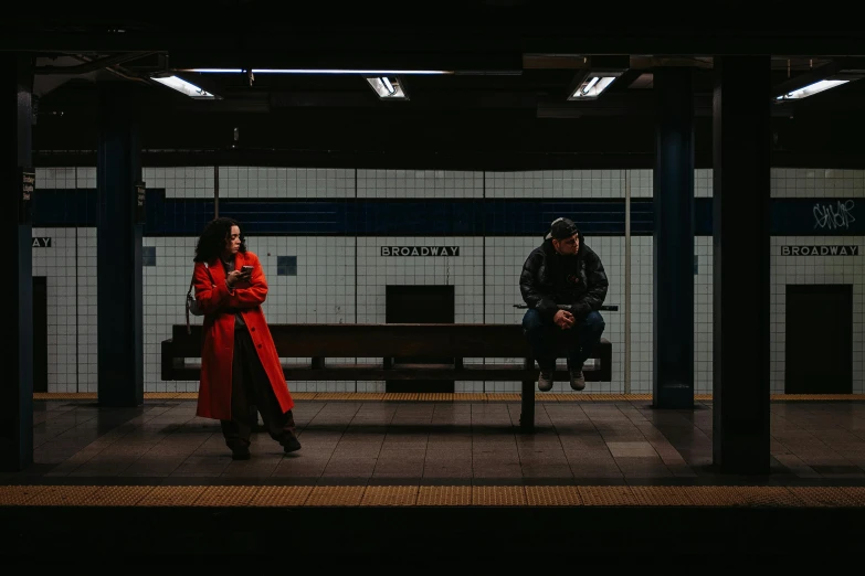 the woman is waiting for the train in the station