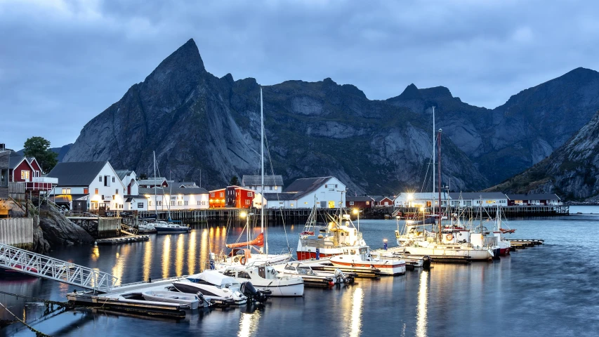 several boats tied up in the water at a pier