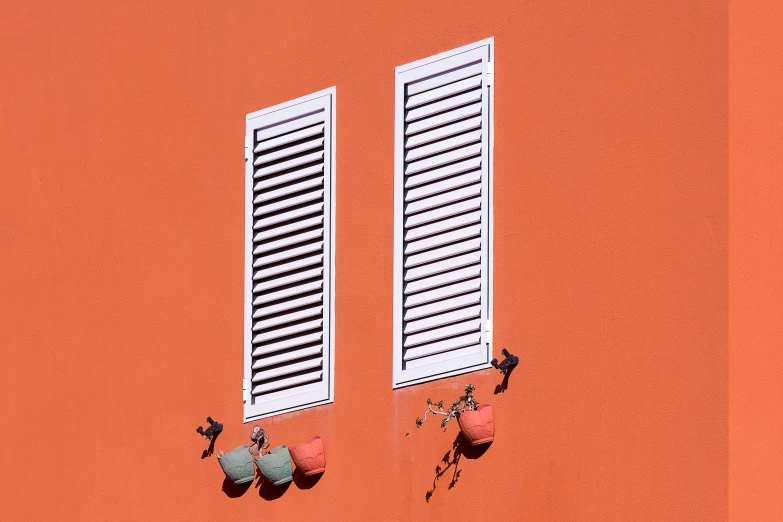 two windows on the side of a building