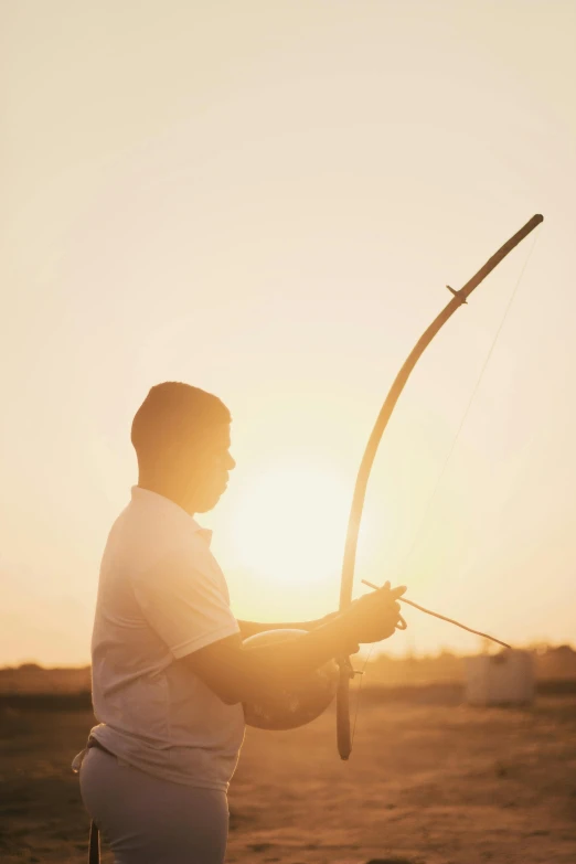 the man holds onto a bow and arrows